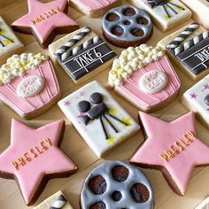 decorated cookies are arranged in the shape of stars and movie claps, with words written on them