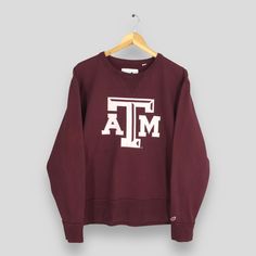 Vintage Texas A&M University Sweatshirt Medium Texas A and M Spell Out Printed Jumper Ncaa Texas Aggies Sweater Texas AM Crewneck Size M Size On Tag :- Size M Manual Measurement :- WIDTH (armpit to armpit) :- 22.5" inches LENGTH (shoulder to end of garment) :- 27" inches WEIGH :- 0.48 kg Condition :- Good Condition. No holes and no stains. - Colors Might Be Different Due To Lighting. - All items are VINTAGE which show some signs of wear and tear. FEDEX EXPRESS = 3-6 business day arrived.  Please Collegiate Crew Top For Winter, Varsity Crew Top For Winter, Varsity Crew Neck Top For Winter, Collegiate Tops With Ribbed Cuffs For Campus, Collegiate Fall Top For Campus, Winter Crew Neck Top For College, Varsity Long Sleeve Tops For Campus, Varsity Cotton Tops For Fall, Cotton Sweater With Logo Print For College