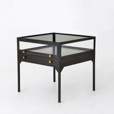 a black table with two drawers and one drawer on the bottom, in front of a white background