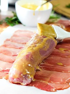 ham is being prepared on a cutting board