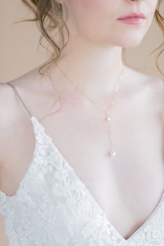 "Style Name: Emily Inspired by and named after one of our brides, the Emily necklace is the perfect simple delicate and modern necklace for a low v neck gown (or every day!) This beautiful delicate cable chain necklace features a Y droplet of our signature freshwater pearl linked with a tiny freshwater pearl at the Y. This necklace is just minimal perfect! ♥ The Fine Details * Hand wire wrapped link of a small 5mm freshwater pearl linked to a chain drop with a single 7-8mm AAA Freshwater pearl c Delicate Clavicle Chain Bridal Necklace For Formal Occasions, Pearl Chain Necklaces For Wedding, Elegant Long Drop Adjustable Backdrop Necklace, Elegant Lariat Jewelry For Wedding, Elegant Adjustable Long Drop Backdrop Necklace, Delicate Pearl Drop Lariat Necklace For Formal Occasions, Dainty Lariat Backdrop Necklace For Formal Occasions, Dainty Bridal Necklace For Bridesmaid Gift, Elegant Backdrop Necklace With Adjustable Chain As Gift