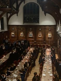 a large dining hall filled with people sitting at long tables