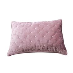 a pink velvet pillow with small white dots on the front and back, sitting against a white background