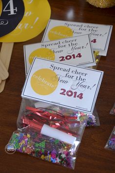 the table is set up with paper tags and plastic utensils for new year's eve