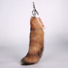 a key chain with a furry tail hanging from it