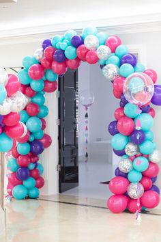 the balloon arch is decorated with balloons and streamers