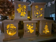 four wooden boxes with christmas decorations on them