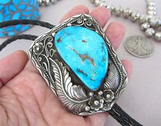 "Hello and thanks for looking! For sale is this LARGE, BLUE, BLUE, BLUE Diné turquoise bolo! The sterling setting were the stone is, is 2.75\" on longest dimension and the sterling tips are 2 5/16th\" long to bottom tiny circular tip on bench beads. The HUGE stone is 1 13/16ths\" on longest side and is of a rich, bright blue with pyrite inclusions and sprinkles, just like Morenci Mine specimens. The back is signed by the Diné artist \"RBP\" and it has the standard \"Bennett Patent Pending\" stam Blue Turquoise Concho Necklace As A Gift, Blue Western Style Jewelry With Inlay, Western Style Engraved Blue Jewelry, Blue Handmade Bolo Tie Gift, Southwestern Blue Turquoise Necklace With Concho, Southwestern Blue Bolo Ties As A Gift, Southwestern Blue Bolo Tie For Gift, Southwestern Blue Concho Jewelry, Vintage Blue Turquoise Necklace With Concho