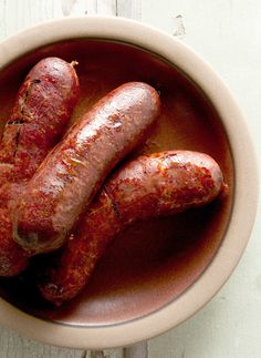 two hot dogs in a bowl on a table