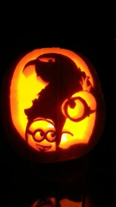 a carved pumpkin with an image of a cat on it's face in the dark