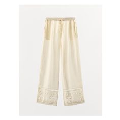 Pants made of viscose and 10% linen blend. Mid-waist shorts with elastic waistband and adjustable drawstring. Side hidden in-seam pockets. Matching tonal lace trim, embroidery and beading appliqué. Wide leg. Bohemian Style Cream Bottoms With Elastic Waistband, Embroidered Straight Beige Pants, Beige Cotton Pants With Floral Embroidery, Beige Embroidered Straight Pants, Embroidered Wide-leg Beige Pants, Embroidered Wide Leg Beige Pants, Embroidered Beige Wide Leg Pants, White Bohemian Bottoms With Drawstring, Beige Floral Embroidered Pants