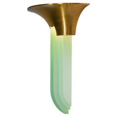 a gold and green light fixture on a white background