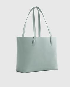 This well designed, full-size, beautiful Italian leather tote bag is perfect for your everyday needs. Includes all the inner organization to keep you on track throughout the day including a 13" laptop slip, iPhone pocket, zipper pocket, plus several other pockets and a hook for your keys. Your go-to everyday tote, no doubt.  | Quince | Women's Classic Italian Leather Tote Bag in Dusk Blue Shopping Tote Shoulder Bag With Laptop Sleeve, Tote Shoulder Bag With Laptop Sleeve For Shopping, Minimalist Laptop Bag With Double Handle, Minimalist Laptop Bag With Double Handle For Daily Use, Minimalist Double Handle Laptop Bag For Daily Use, Modern Shoulder Bag With Laptop Sleeve For Shopping, Blue Shoulder Bag With Laptop Sleeve For Everyday, Blue Leather Everyday Laptop Bag, Blue Leather Laptop Bag