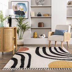 a living room with a rug, chair and bookcase