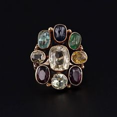 This vintage ring (circa 1960-1970) features assorted gemstones in 14k gold. The gemstones include garnet, zircon, emerald, sapphire, aquamarine, and chrysoberyl.   The face of the ring measures 0.9 inches by 0.8 inches wide and is in very good condition with light surface wear.  The ring is currently a size 6, but it can be resized free of charge. We have many other fantastic offerings of fine jewelry posted on our Etsy store, so please consider browsing our other items. We send all items in in Multicolor Multi-stone Emerald Oval Ring, Bronze Gemstone Vintage Jewelry, Multicolor Multi-stone Emerald Ring, Vintage Multi-stone Oval Sapphire Ring, Vintage Oval Multi-stone Sapphire Ring, Antique Gold Multi-stone Ring, Luxury Vintage Collectible Gemstones, Vintage Gold Cabochon Gemstones, Antique Multicolor Multi-stone Jewelry