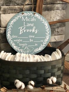 a basket filled with cotton sitting on top of a table next to a brick wall