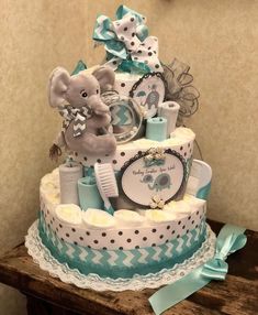 a baby shower cake with an elephant and diaper on it's tiers