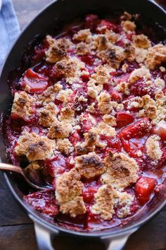 a pan filled with food sitting on top of a wooden table