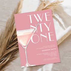 a pink card with the words two sixty one on it next to some dry grass