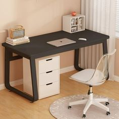 a computer desk with a laptop on top of it next to a white chair in front of a window