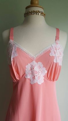 What a peach! 🍑 This darling vintage slip features a fresh apricot-pink hue; crisp white floral lace trim; a graceful, gathered bustline; and a double-lined front panel. Excellent condition. Size: 34 Era: 1960s Label: none, has a blue and white ILGWU tag Material: 100 percent nylon Length: 37.5 inches ♡ more rare and beautiful treasures on Instagram at provenance_vintage 1980 Fashion, Nightgown Dress, Dress Lingerie, Vintage Slip, Vintage Slips, Salmon Pink, Vintage Lingerie, Green Silk, Wool Dress