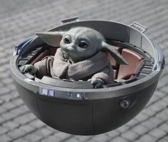 a baby yoda is sitting in an electronic device