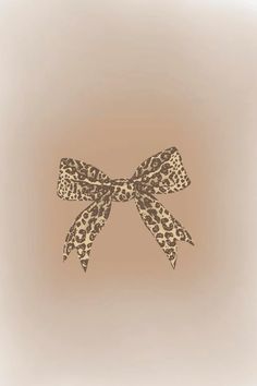 an animal print bow on a beige background with the word love written across it in black ink