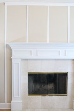 an empty fireplace with white paint on the mantle