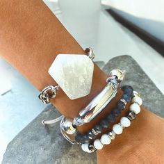 Elevate your style with this stunning bracelet set that combines modern elegance with boho chic vibes. The set features a striking white hexagon stone centerpiece, a sleek silver bar accent, and a mix of faceted beads in shades of black, white, and silver. Each bracelet is designed to be adjustable for a perfect fit and can be worn individually or stacked together for a layered look. Whether you're dressing up for a special occasion or adding a unique touch to your everyday outfit, this bracelet Bohemian Metal Beaded Stackable Bracelets, Stackable Bohemian Metal Beaded Bracelets, Bohemian Metal Beaded Bracelets For Everyday, Adjustable Faceted Bohemian Crystal Bracelet, Adjustable Faceted Crystal Bohemian Bracelet, Bohemian Adjustable Faceted Crystal Bracelet, Bohemian Silver Wrap Bracelet With Faceted Beads, Bohemian Crystal Bracelet For Everyday, Bohemian Silver Faceted Beaded Bracelets