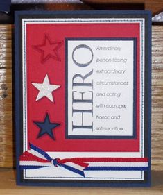 a red white and blue card with stars on the front, and an american flag ribbon around it