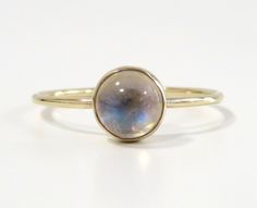 Iridescent, soothing and beautiful. This rainbow moonstone ring is made from 14k gold filled or sterling silver material and set with a natural rainbow moonstone. Whether you're buying this beautiful moonstone ring as a gift or for yourself, it will help with inner growth and bring forth new beginnings and inspiration. Handmade in Los Angeles, CA!  *Each stone is unique and there may be slight color and height differences. We handpick the most beautiful stones! Packaging:  Comes in a gift box, r Celestial Stackable Moonstone Ring, Celestial Style Stackable Moonstone Ring, Celestial Moonstone Ring In Yellow Gold, Gold Delicate Moonstone Ring, Delicate Gold Moonstone Ring, Mystical Moonstone Birthstone Ring, Stackable Opal Ring, Round Shape, Gold Moonstone Ring With Moon Phase Detail, Celestial Round Moonstone Ring