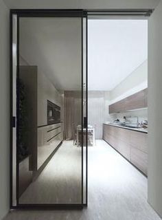 an open kitchen with sliding glass doors leading into the dining room