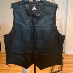 Nwot Arian Men Black Leather Motorcycle Vest/Casual Vest Sz. Large. Premium Quality Leather: Made From High-Quality, Genuine Leather That Is Soft, Supple, And Durable. It Offers Both Comfort And Longevity, Ensuring That It Will Withstand The Test Of Time. The Vest Is Adorned With Carefully Crafted Design Details Such As Intricate ... The Vest Features Functional Pockets, Providing You With Convenient Storage Options For Small Essentials Like Keys, Cards, Or A Smartphone. The Classic Leather Cons Casual Leather Vest, Black Casual Leather Vest, Casual Black Leather Vest, Safari Vest, Motorcycle Vest, Black Puffer Vest, Casual Vest, White Polo, Black Puffer