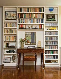 a room filled with lots of books and furniture