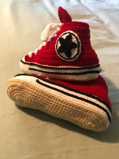 a crocheted red sneaker with a black star on it