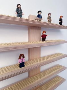 there are lego people standing on the shelves