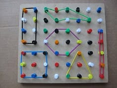 an assortment of different colored balls and sticks on a piece of paper with a white background