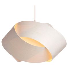 a white light hanging from the ceiling with a circular shade on it's side