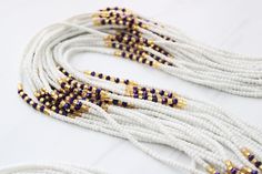 Traditional waist beads hand crafted in Ghana. Made with white glass seed beads and metallic purple glass crystal accents. Strung on cotton string with no clasp. Fits up to 42 INCHES Comes with one strand Bead size - Small White Tiny Beads Waist Jewelry For Festival, Adjustable White Waist Beads For Festival, Adjustable White Waist Beads With Tiny Beads, White Beaded Waist Beads As A Gift, White Beaded Waist Beads As Gift, Adjustable White Bohemian Waist Beads, Handmade Adjustable White Waist Beads, Adjustable White Waist Beads With Spacer Beads, Adjustable White Waist Beads With Gold Details