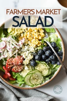 a salad with blueberries, cucumbers and other vegetables on it in a bowl