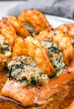 salmon with spinach and cheese served on a white plate