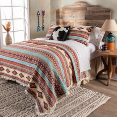 a bed in a room with a wooden headboard and pillows on top of it