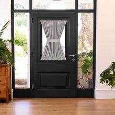 a black front door with a white curtain on the side and potted plant next to it