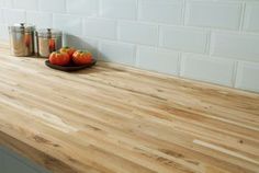 a wooden counter top in a kitchen next to jars