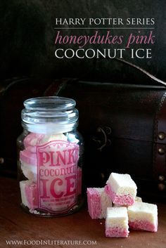 pink and white marshmallows in a jar next to a brown leather bag