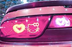 the back end of a car with hearts painted on it's tail lights and numbers