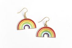 "These sweet rainbow earrings can't wait to spruce up your festival outfit with some serious retro-boho charm! Earring hooks are hypoallergenic. ▲ Rainbow charms measure approx. 1\" x 1 1/8\" ▲ Gold-plated surgical steel earring hooks (hypoallergenic) We try to display product colors as close to life as possible. However, all computer monitors are different and so there might be slight color variations from screen to screen. If you have any questions, feel free to contact us! CARE INSTRUCTIONS J Rainbow Nickel-free Earrings For Gifts, Nickel-free Rainbow Earrings For Gift, Nickel-free Rainbow Earrings Gift, Rainbow Hypoallergenic Earrings As Gift, Colorful Hypoallergenic Dangle Jewelry, Everyday Rainbow Jewelry For Summer, Multicolor Nickel-free Retro Jewelry, Retro Multicolor Nickel-free Jewelry, Everyday Summer Rainbow Jewelry