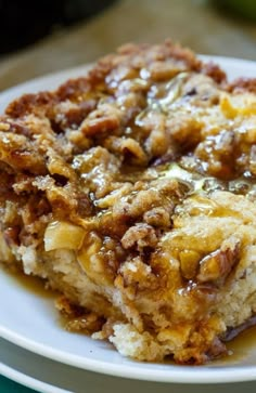 a close up of a plate of food on a table with an apple in the background