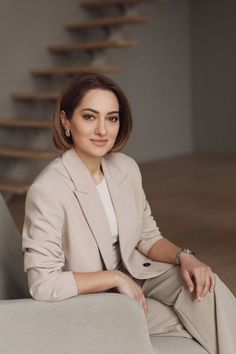 a woman sitting on top of a white couch