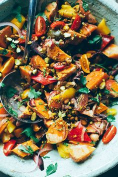 a bowl filled with lots of food on top of a table